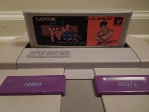 You can play Super Famicom games on your SNES by removing 2 plastic tabs that are located inside the cartridge slot - it's not difficult. 